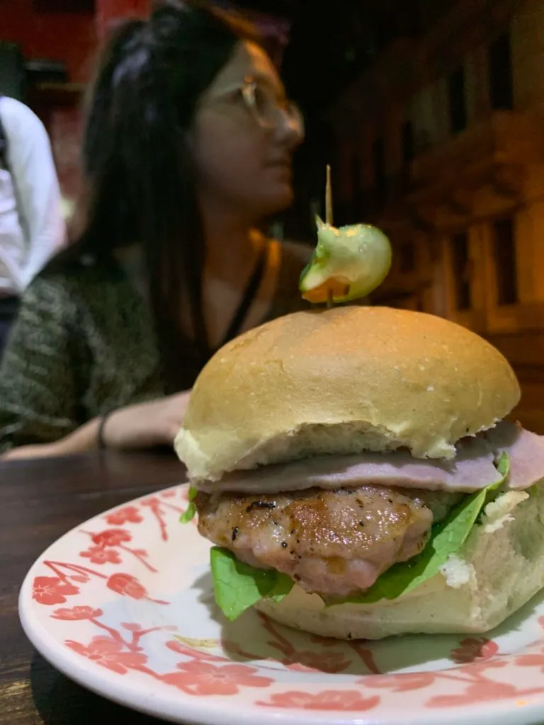 Cuban hamburger sandwich with ham patty and lettuce on a plate