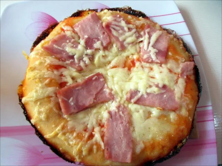 Cuban ham and cheese pizza on a plate