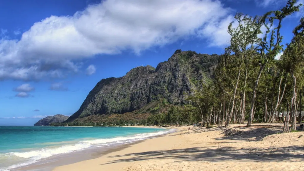 Waimanalo Beach with turquoise water and dramatic mountain cliffs