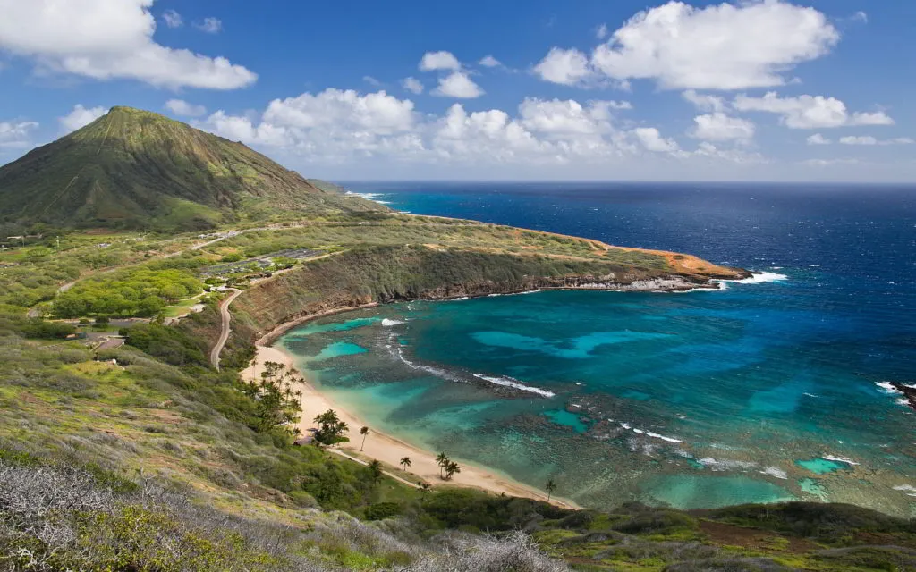 Aerial view of Hanauma Bay with turquoise water and green hillside