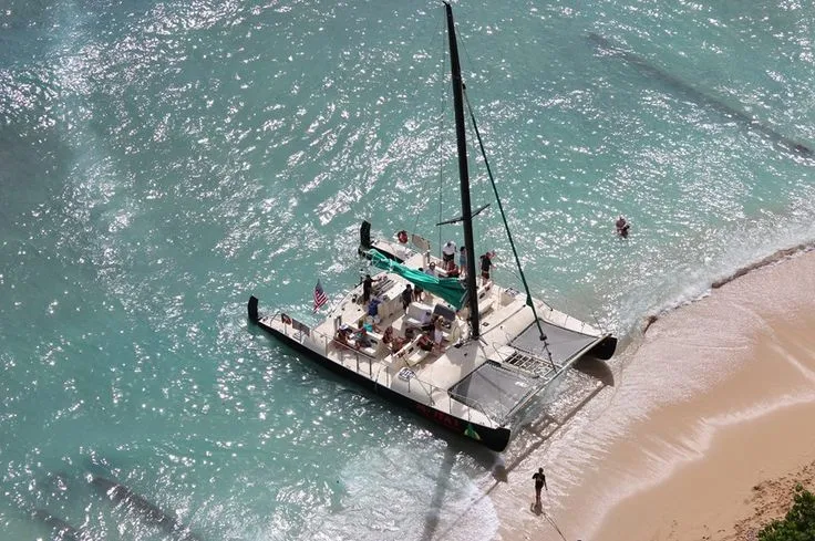 Catamaran booze cruise boat anchored near Waikiki shoreline