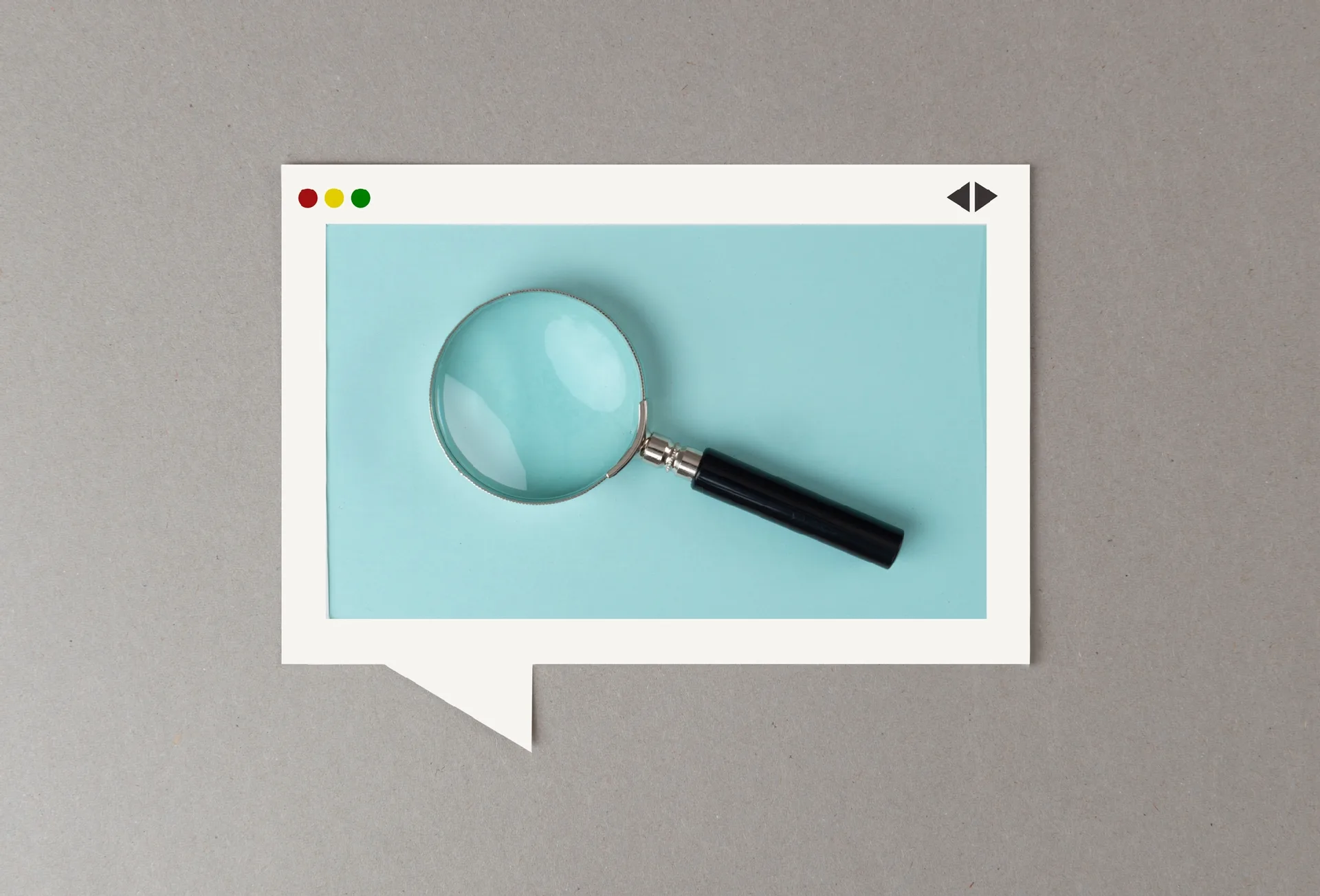Magnifying glass inside a paper cutout of a browser window shaped like a speech bubble